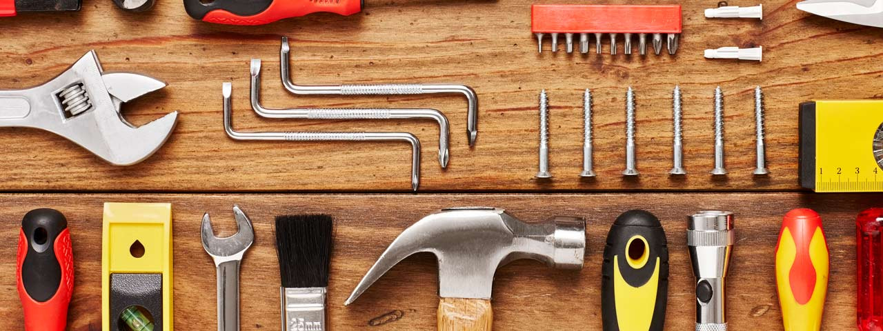 Tools organized on a wooden work surface